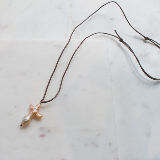 The SOLENE Pearl Cross Necklace on Brown Cord